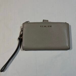 Michael Kors pebbled leather wallet with wrist strap. Taupe/gray color